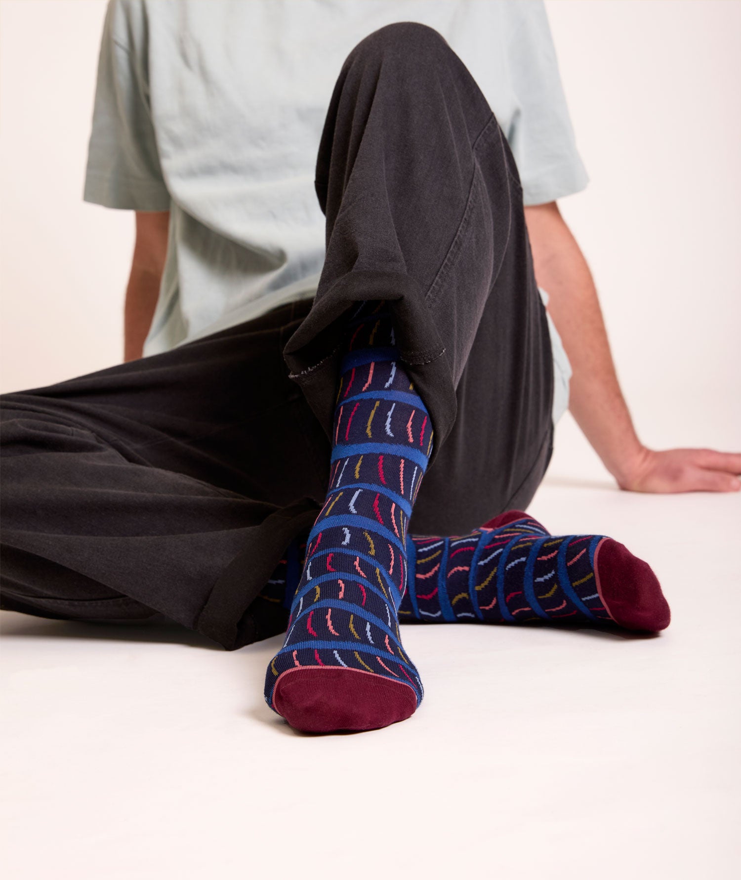 Calze con fantasia a serpentina lunghi da uomo. Fondo blu, con punta e tallone bordeaux.